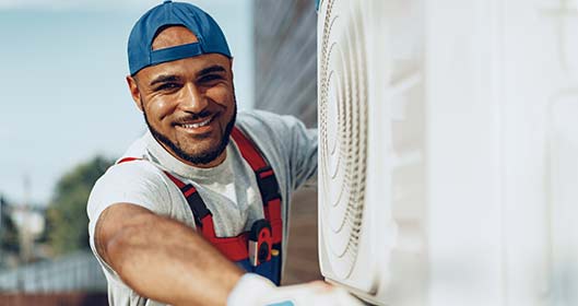 technician works on outdoor ac repair